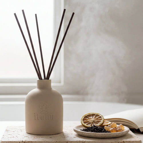 Diffuser with sticks on a marble surface near a window